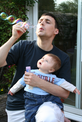 Thumbnail of Emma watching David blow bubbles.jpg